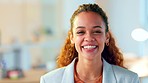 Portrait of a confident young businesswoman smiling and laughing in an office. One cheerful entrepreneur and ambitious young expert feeling excited and optimistic for success in her startup company
