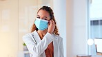 Happy businesswoman removing her surgical face mask at the end of the coronavirus pandemic. Excited or relieved business woman feeling confident in an office work environment after getting vaccinated