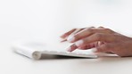 Closeup of a businesswoman browsing on a computer keyboard against a white background. Hands of a productive entrepreneur typing emails and compiling online reports while doing research and planning