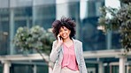 Confident female real estate agent talking on the phone while walking outdoors in the city. A successful African woman realtor selling building property in an urban town. Saleswoman on a call outside