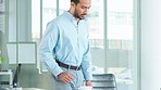 Financial advisor sitting at a desk while sending and typing emails on a desktop computer in an office alone at work. One young and serious Asian finance manager arriving at work and browsing online