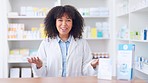 Happy female chemist welcoming customer to the pharmacy. Isolate lady standing behind counter, the medicine that she can recommend on the shelves behind her. Young pharmacist is eager to help.