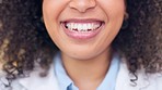 Happy female pharmacist smiling and looking cheerful. Closeup mouth of joyful african medical worker with an afro showing her teeth. A friendly and cute chemist working in a pharmacy or drugstore