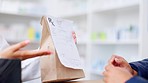 Healthcare worker explaining dosage instructions to a woman collecting a bag of over the counter and prescription medication in a drugstore. Pharmacist helping a customer with medicine in a pharmacy