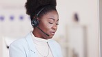 Portrait of a friendly call center agent using a headset while consulting for customer service and sales support. Young business woman with a big smile working on a computer and operating a helpdesk