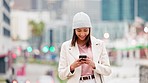 Trendy stylish woman navigating with phone GPS in a new beautiful city. A young confident and happy female walking and updating her social media posts while strolling outside in an urban town