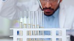 Medical science technician analyzing and testing samples for a medicine drug to treat a viral virus disease. Male professional scientist working in a biotechnology lab doing a clinical trial research