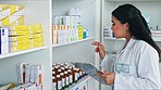 Pharmacist checking clipboard for medication pills stocktake in clinic pharmacy. Medical healthcare professional counting over counter drugs, prescription medication before selling or helping patient