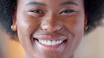 Confident and proud black woman smiling, showing strength and dignity. Closeup of the face and head of a beautiful young african american female showing her teeth with a big smile and feeling happy
