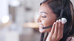 Call center agent helping client in a phone call giving great customer service. Customer support employee consulting clients online using headset. Professional friendly woman working at her desk