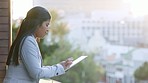 Businesswoman using digital tablet to monitor business progress, profit and loss while standing alone on office balcony. Serious corporate executive using technology to plan success or innovate ideas