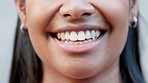 Closeup of the smile of a female student laughing and looking cheerful while standing on campus at a university alone. Zoom of one joyful girl showing off her bright smile and perfect white teeth