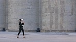 Woman wearing VR glasses while walking outside and exploring the metaverse. Female with ai 3D goggles, talking and interacting with virtual reality. Woman watching her empty office space come to life