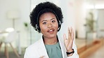 Female call center agent talking to a customer, selling or marketing a product. Portrait of a cheerful African American business woman wearing headset working and standing in a professional office