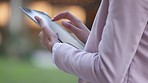 Event planner standing outdoors using app to organize a house party.  Closeup of hands of businesswoman scrolling on tablet. Idea conception, preparation and logistics in creation of experiences