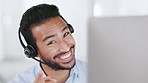 Laughing call centre agent wearing headset, using hand gesture to point at next client and using computer to promote sales or deals. Portrait of friendly, cheerful customer service operator in office