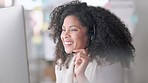 Happy female customer service agent smiling while working in a call centre, talking to a client with a headset. A helpful saleswoman assisting customers with purchase orders and questions online