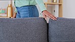 Relaxation, comfortable and resting couch being felt by a potential buyer or customer at a furniture shop, depot or store. One person feeling, touching and rubbing a sofa with hands at home or work 