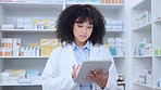 Portrait of black pharmacist doing inventory on a digital tablet. African American chemist ordering medication at a modern drugstore. Health care professional ready to assist at a clinic dispensary 