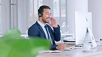 Call centre agent using computer to finish or complete sales deal and feeling relieved with hands behind his head. Receptionist or customer service operator sitting alone and using office technology