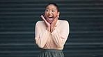 Shocked, surprised and excited female celebrating good news against dark background. Black woman expressing surprise with an open mouth and omg gesture, thrilled with a promotion or positive result