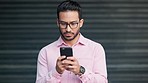 Stressed, anxious and worried business man feeling pressure or strain to reply to a text message on his phone. Young male shaking while experience anxiety or panic due to the bad news of being fired