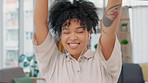 Carefree, stressless and happy black woman wearing earphones and dancing while working in a modern office. Portrait of an excited African American female with lots of energy celebrating good news 