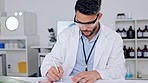 A satisfied and calm scientist resting after working in a lab and taking a break. A confident, happy and relaxed young science researcher or professional done with a task and relaxing in a laboratory