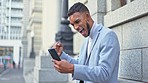 Excited, overjoyed and successful businessman celebrating win with mobile phone outside. Young entrepreneur screaming in happiness at online prize. Fist pumping air with happiness. 