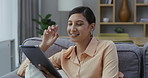 Beautiful, happy or relaxed woman with tablet browsing social media, reading gossip online or joining dating site. Portrait of smiling, cheerful lady reading fake news and sitting on living room sofa