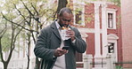 Young professional texting on a phone, eating and walking in a city, reading social media news on his daily commute to work. Hungry worker enjoying an easy breakfast while having an online chat