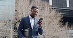 Businessman reading good news on phone, looking at success message or email for a great work or job opportunity. Smiling corporate worker walking in urban city browsing internet with latest cellphone