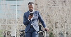 Serious, corporate and reading business man looking at text on phone, commuting to work and searching for location while traveling in city. Young, professional and black employee looking at gps