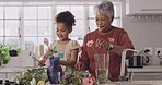 Senior woman and granddaughter bonding, making beautiful spring flower bouquets and talking in home kitchen. Grandmother taking care of cute child on the weekend while making decorative floral vases.