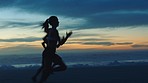 Active, fit and fast athletes running, jogging and sprinting on a beach at sunset. Shadow, outline and silhouette of two motivated women with stamina doing workout, exercise and training by the ocean
