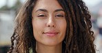 Trendy, edgy and happy young woman smiling and feeling positive outside on a blurred background. Closeup portrait of the face and head of beautiful female with edgy dreadlocks and piercing accessories
