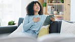 Ethnic woman relaxing and talking on her tablet. Technology and innovation aids people from a distance. Casual, happy and free afro lady laughing while speaking with their friend online and indoors.