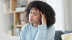 Stressed, anxious and moody African American woman at home with headache. Problems, issues and worry causing pain and tension. Work, family or personal complications causing health trouble