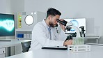 Healthcare analyst, medical technician and scientist working in a science lab. Young doctor doing a test or an experiment, writing his research in a study book while developing a treatment or vaccine