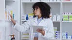 Pharmacy stocktake on tablet by pharmacist, medical and healthcare professional checking drugs, pills and medicine. Serious expert with afro counting over counter or prescription drugstore medication