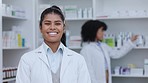  Pharmacist, healthcare worker or medical student doctor smiling in a pharmacy. Young, happy and cheerful clerk standing with medicine and pills for patient pain, healing and wellness behind her