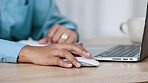 Isolated closeup of business woman hands typing on a laptop and clicking a mouse on a work or home office desk. Female entrepreneur sending and email to colleagues or clients or using the internet.