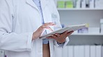 Pharmacist, doctor and healthcare worker scrolling, browsing and planning on a digital tablet in a drugstore, pharmacy lab or clinic. Closeup of woman doing medical, scientific and online research