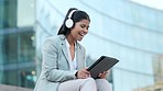 Business woman talking, waving and greeting on a vdeo call, meeting and sitting in the urban city alone. One Indian entrepreneur, freelancer and professional making conversation and discussing