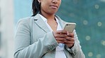 Closeup of a woman texting on a phone while outside in the city. Young female browsing social media or checking online messages on her way to work. Lady scrolling the internet on her daily commute