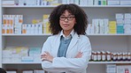 Portrait of confident black health care worker with folded arms, proud while working in a modern drug store. African American pharmacist ready to assist, help or guide medical, health and treatment