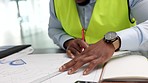 Architect or engineer hands drawing design plans or blueprint for a home or business architecture close up. Professional African American busy planning for future building project at an office desk 