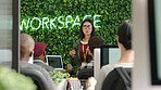 Woman gives work presentation on laptop, coaching workers in leadership or teamwork. Businesswoman with computer on at tech startup train employee staff in audience new strategy or show research.