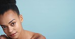 Natural beauty, skincare and black woman model with a healthy, wellness and clear skin look. Portrait of a healthy young woman from Zambia pose for a cosmetic care brand with a blue background