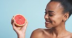 Grapefruit vitamin c, fruit health and black woman with food for beauty skincare, wellness and natural product against blue mockup studio background. Portrait of model with nutrition diet for body